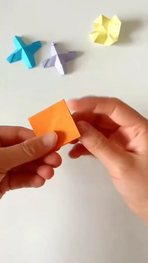 All four corners folded inward toward the center to form smaller square